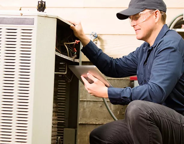 An HVAC technician is installing a new air conditioning unit.